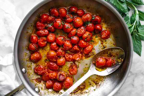 A pan filled with blistered tomatoes