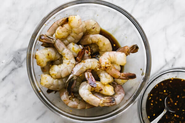 Marinating honey garlic shrimp in a large glass bowl