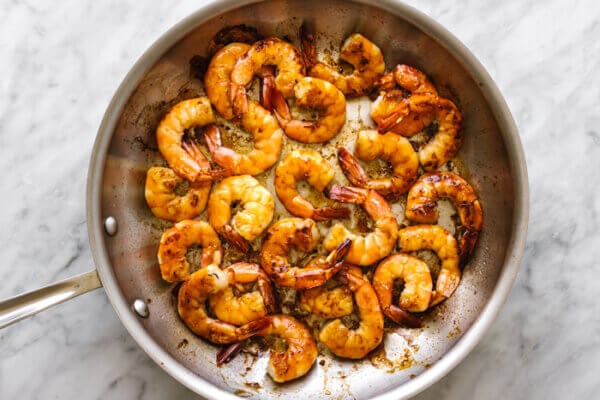 Cooking shrimp in a pan for honey garlic shrimp