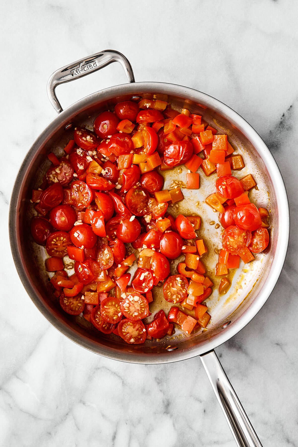 This Mediterranean ground beef stir-fry will be your new go-to dinner. It's easy, healthy, packed with protein, and delicious! Cooked tomatoes in a pan.