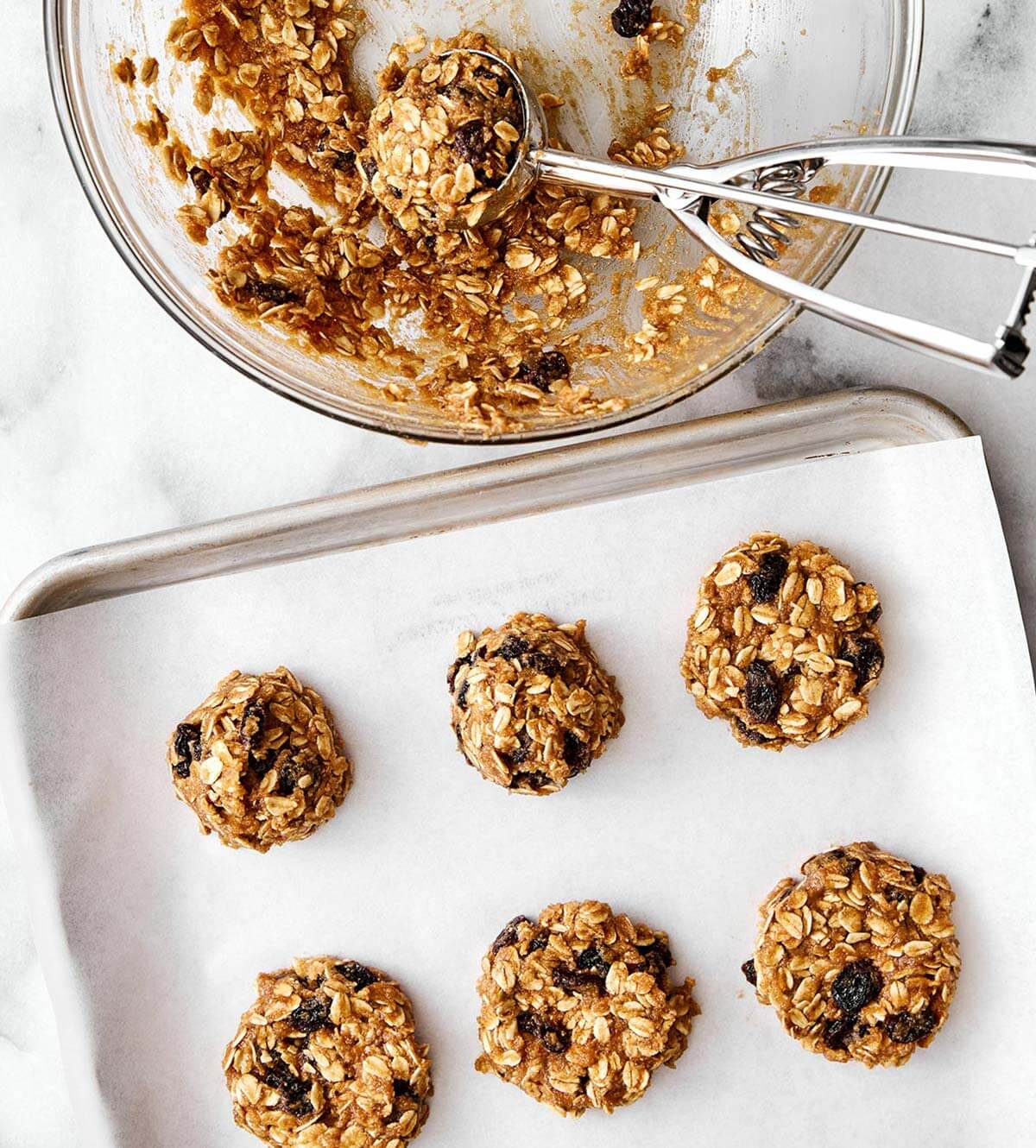 These are everything you want in a healthy oatmeal cookie! They're soft and chewy, perfectly spiced, and dotted with raisins. Molding oatmeal cookies on sheet pan.