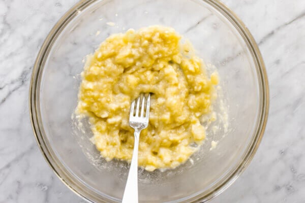 Mashed banana in a bowl for banana oatmeal cookies.