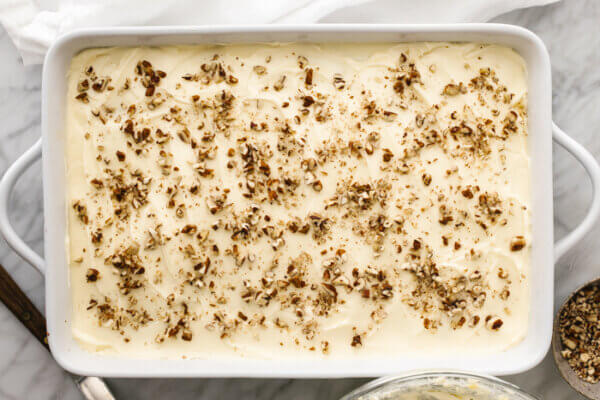 Gluten-free pumpkin pie in a dish with frosting on top.