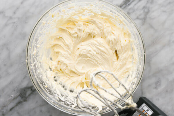 Cream cheese frosting for gluten-free pumpkin cake in a bowl.