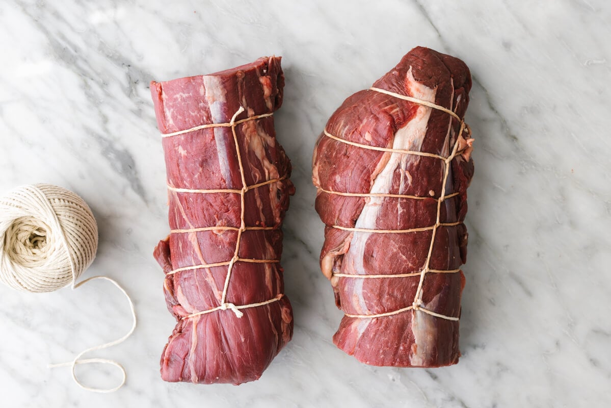 Beef tenderloin tied in string on a table