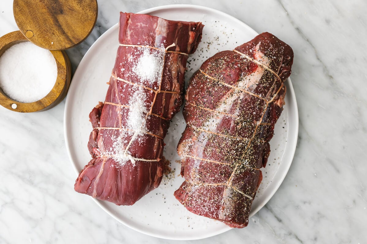 Seasoning beef tenderloins with salt and pepper