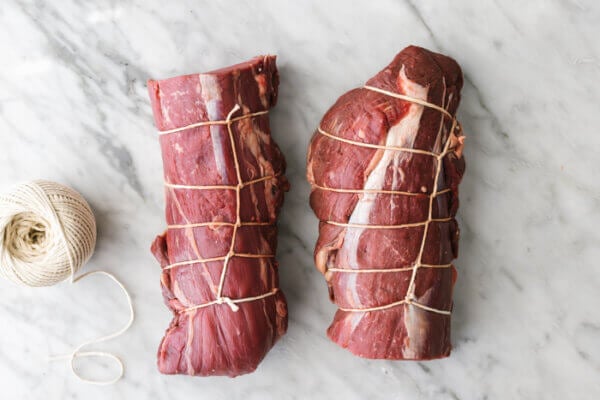 Tied up beef tenderloin on a table
