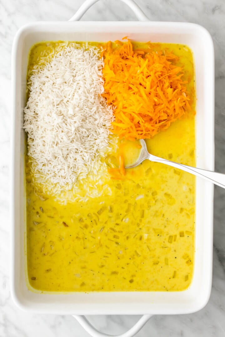 Adding ingredients into a pan for turmeric chicken and rice casserole