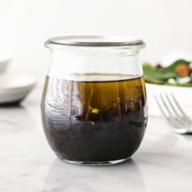 A jar of balsamic vinaigrette on a table