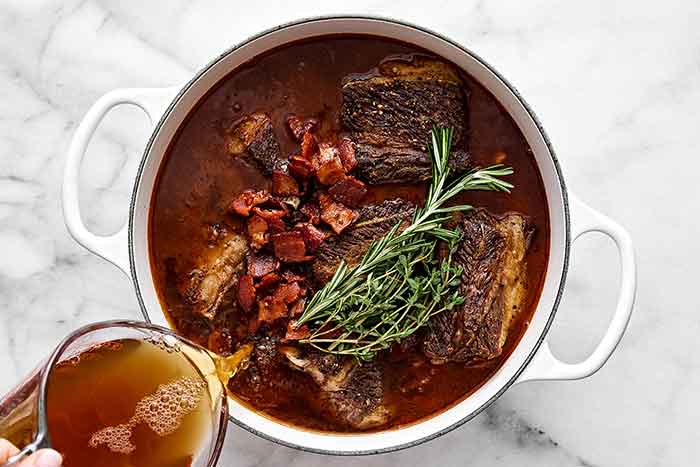 Cooked braised short ribs in a pot.