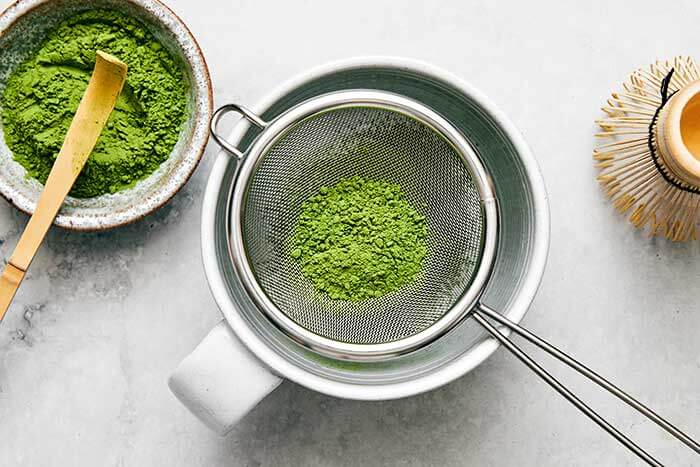 Matcha powder in a sieve.