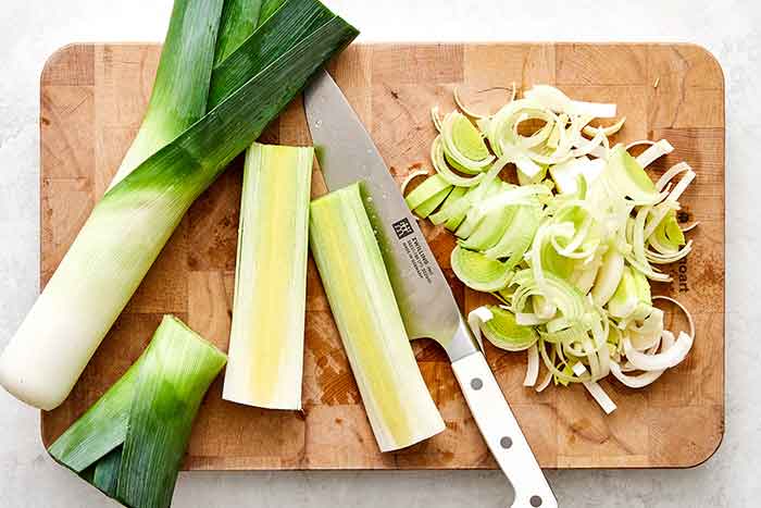 Sliced leeks on a board.