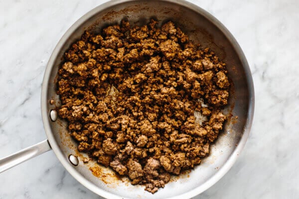 A pan with cooked ground beef for nachos