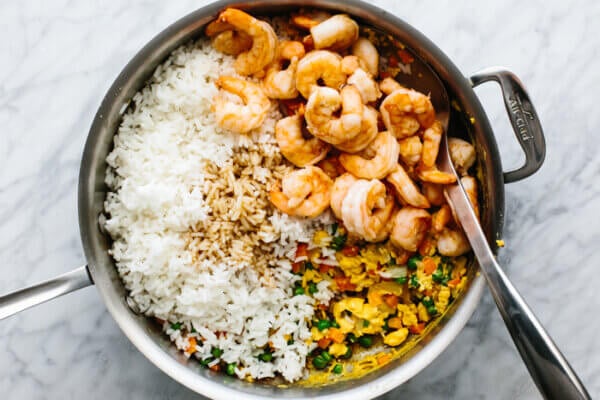 Stir frying shrimp fried rice in a pan