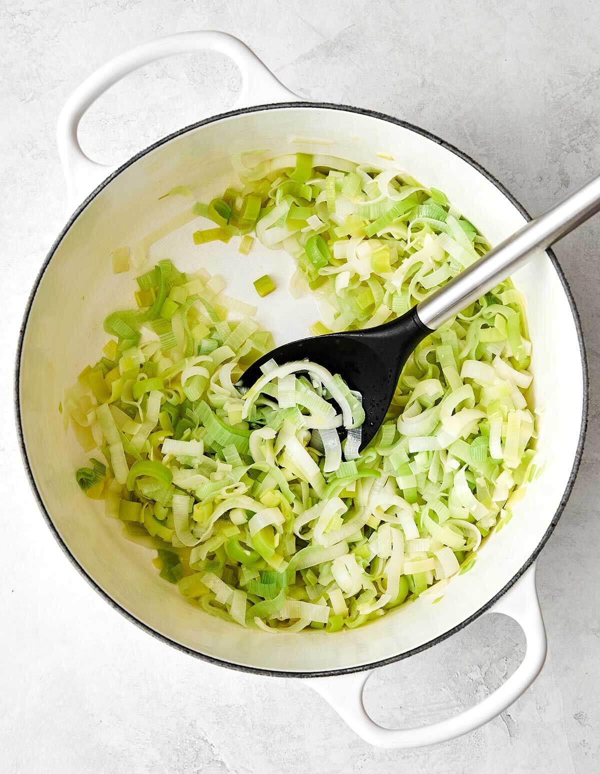 Sauteing leeks in a pot.