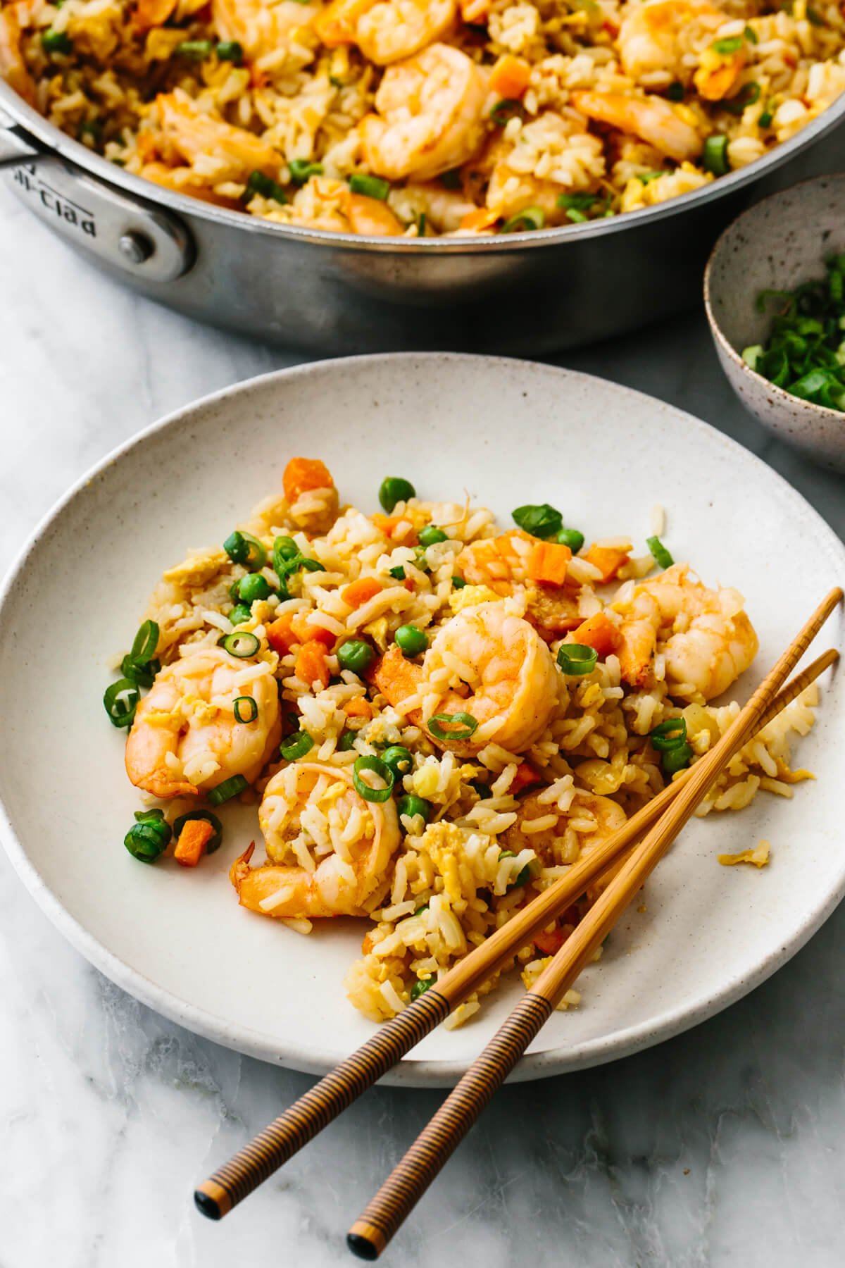 This shrimp fried rice encompasses the best of Chinese take-out in a quick 35 minutes. Aka - the best stir-fry recipe for dinner! A plate of shrimp fried rice with chopsticks