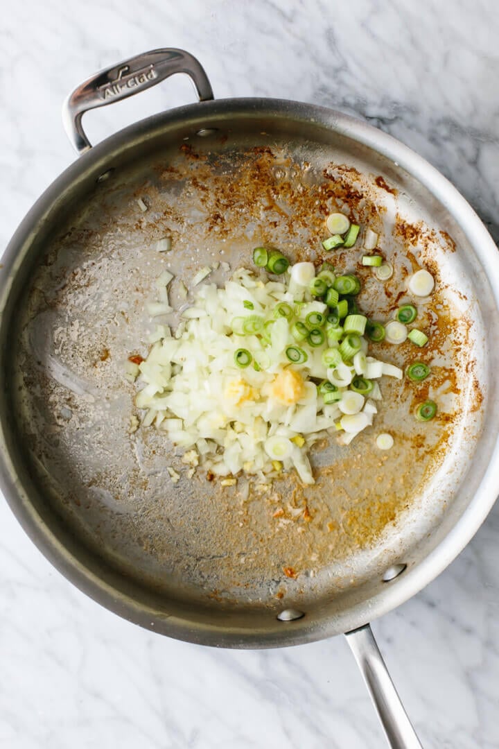 Cooking aromatics in a pan for shrimp fried rice