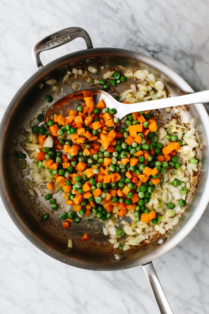 Cooking veggies in a pan for shrimp fried rice