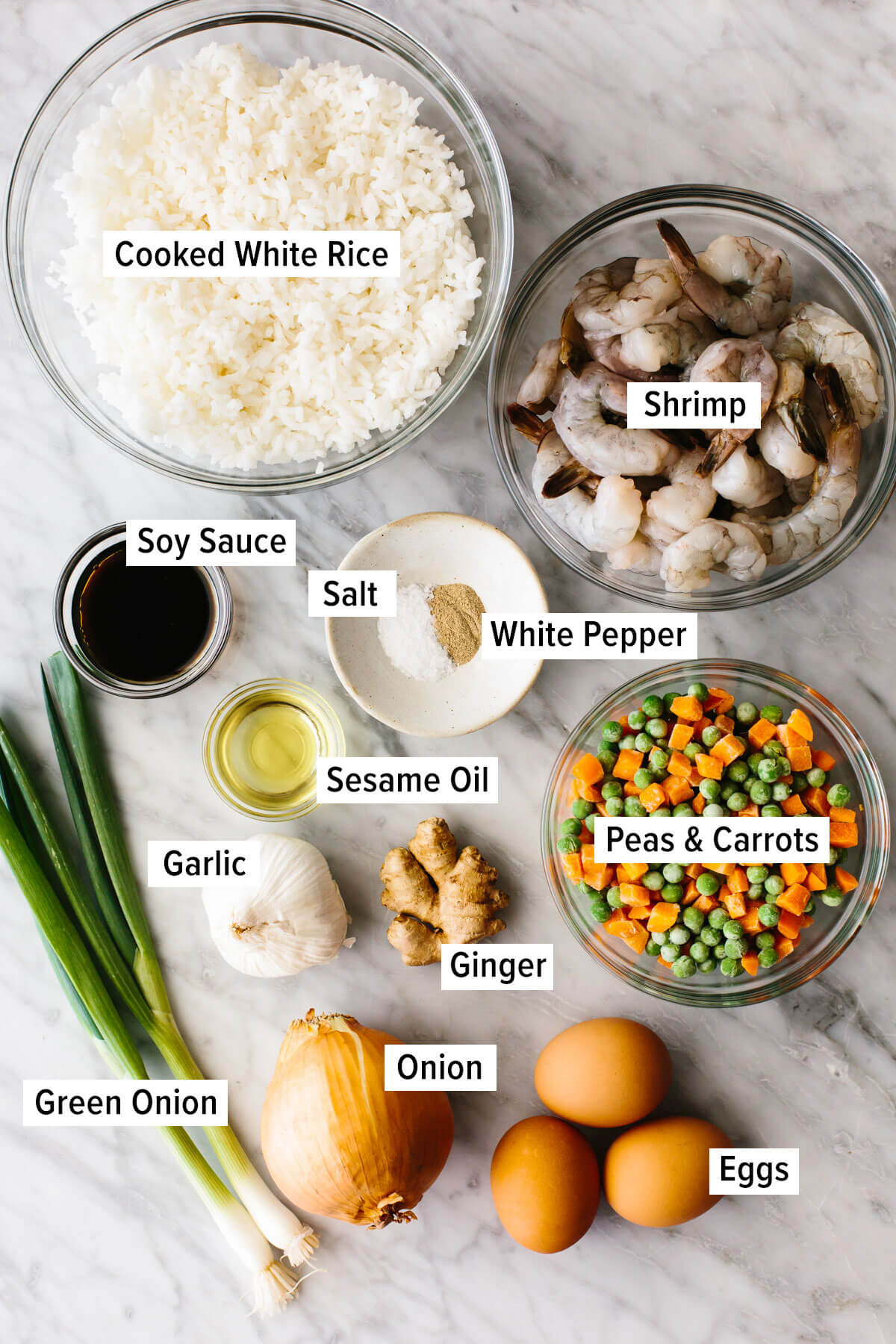 This shrimp fried rice encompasses the best of Chinese take-out in a quick 35 minutes. Aka - the best stir-fry recipe for dinner! Ingredients for shrimp fried rice on a table
