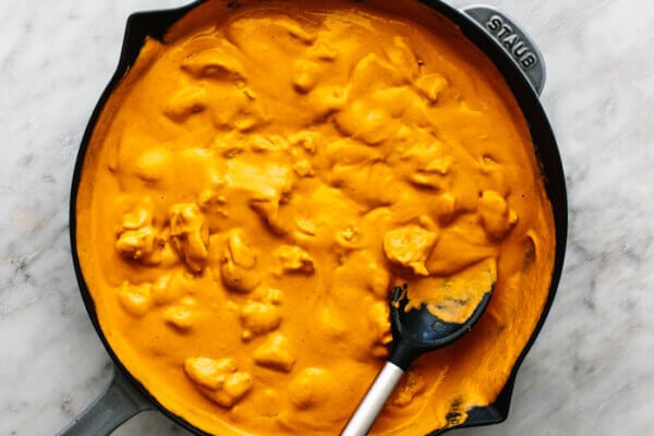 A large skillet with butter chicken