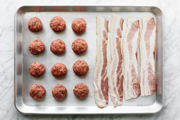 A sheet pan of bacon and burger balls for guacamole bacon burger bites