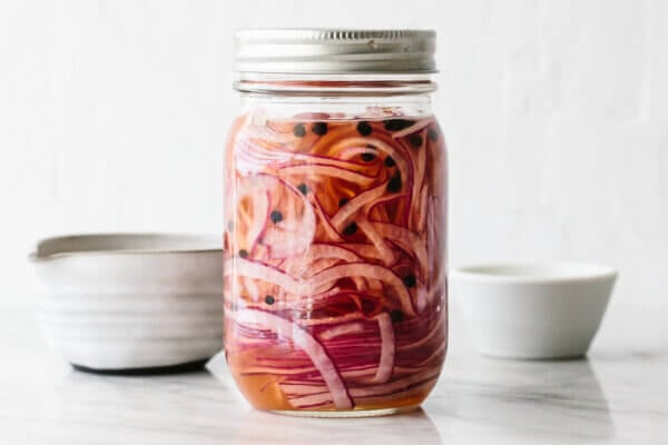 A mason jar of pickled red onions