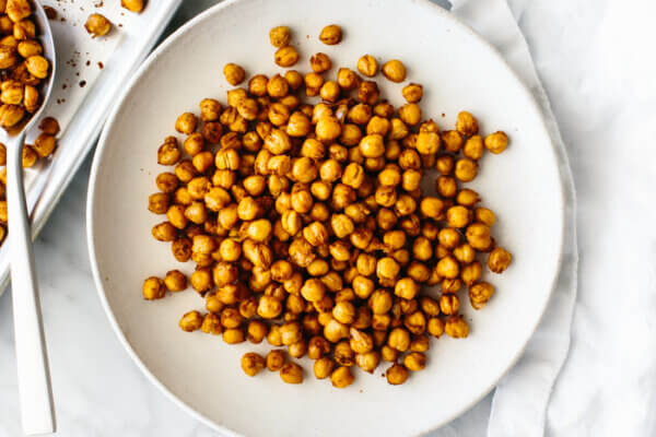 A white plate with roasted chickpeas