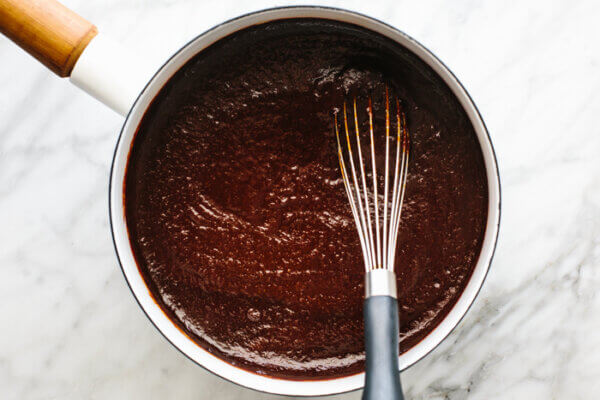 A white pot simmering homemade bbq sauce