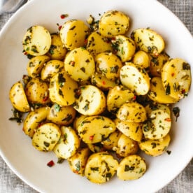 A big white bowl of chimichurri potato salad