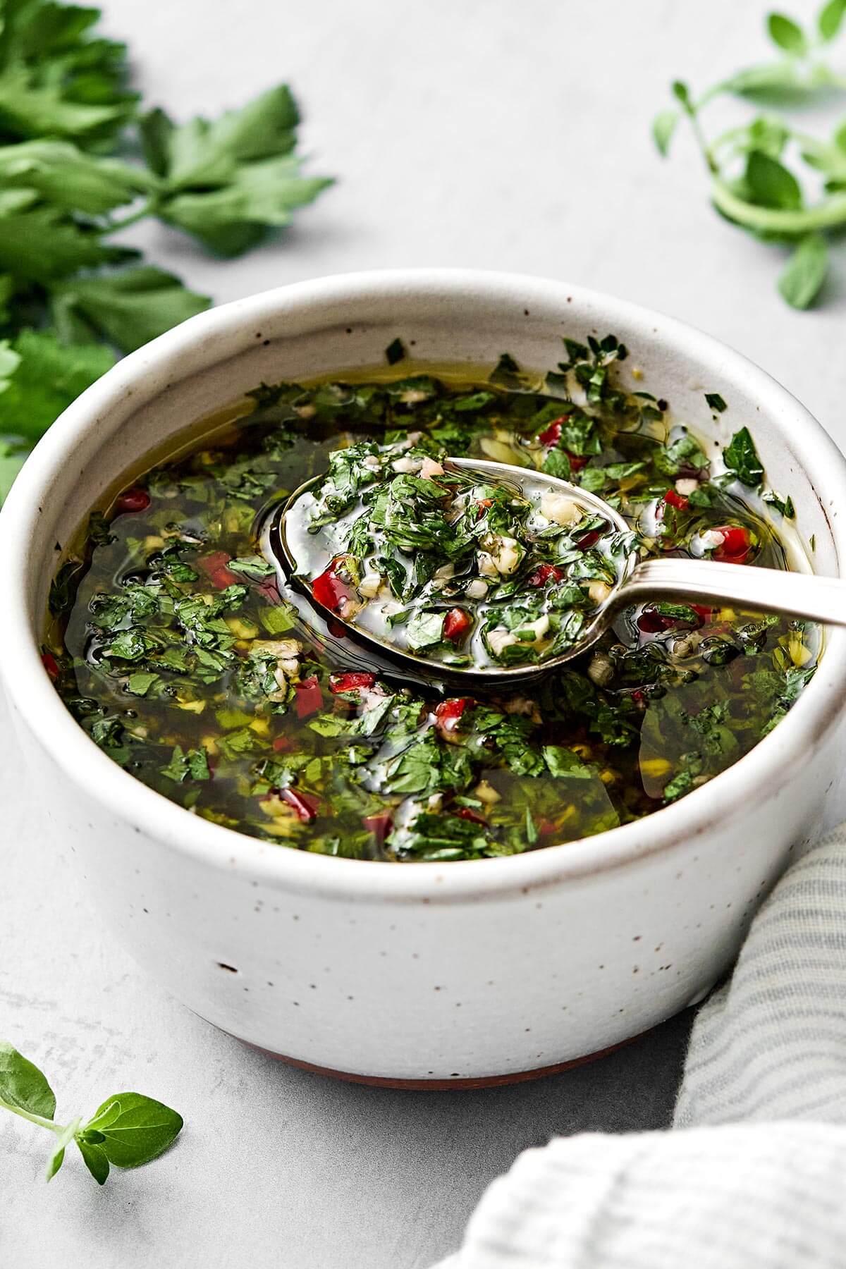 The perfect sauce for grilled meats, vegetables, and more! This chimichurri sauce is packed with herbs and fresh, tangy flavors. Chimichurri sauce recipe in a bowl.