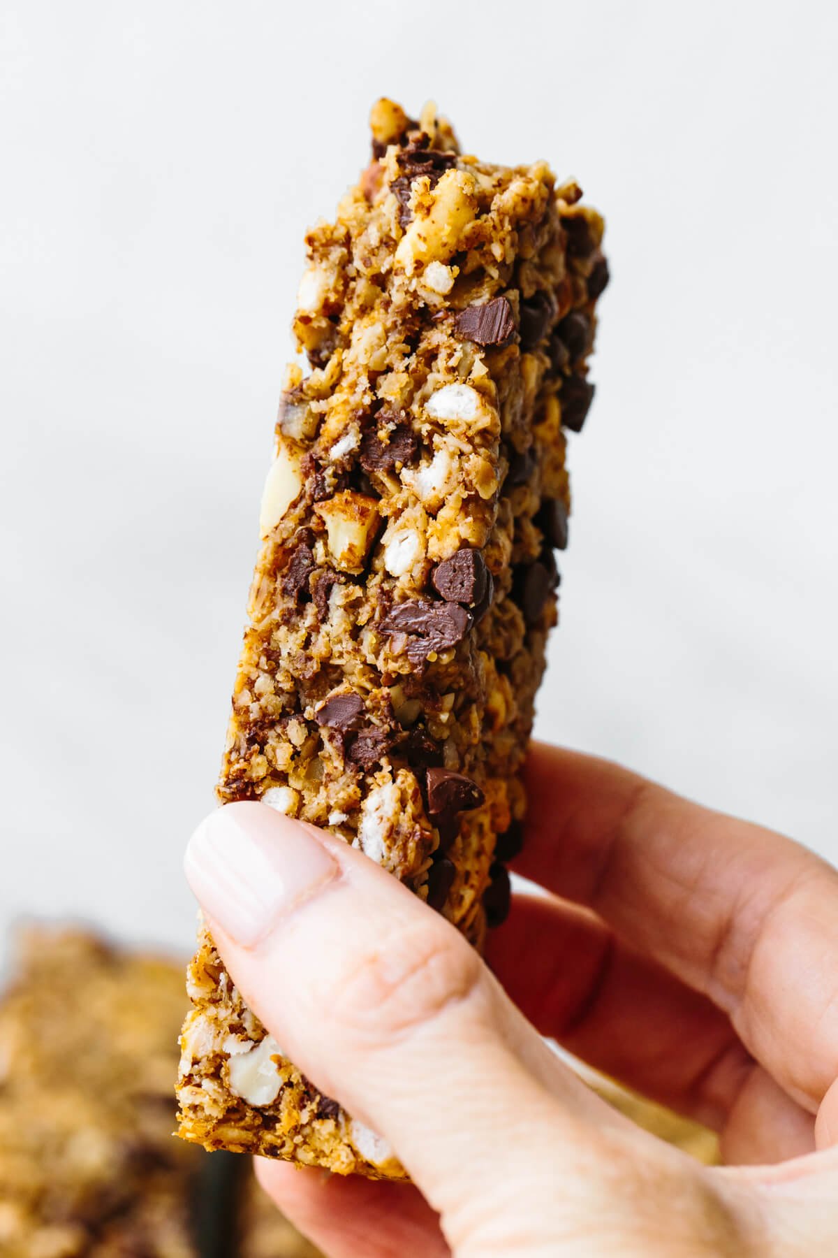 Holding a chewy chocolate chip granola bar
