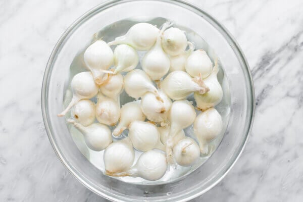 A bowl of boiled pearl onions for roasted radish salad