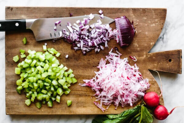Diced vegetables on a board for salmon salad