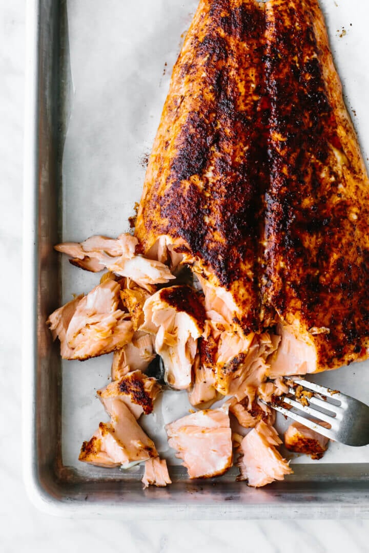 Flaked baked salmon on a sheet pan for salmon salad