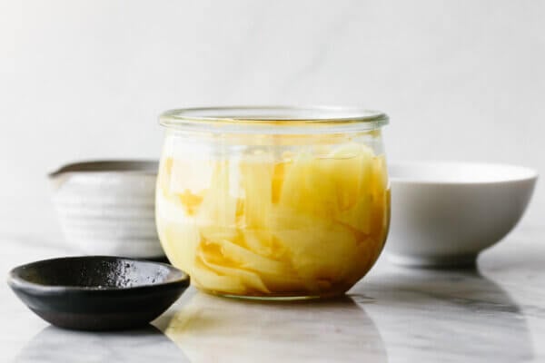 A jar of quick pickled ginger next to little bowls
