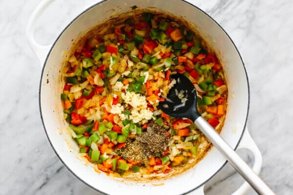 Cooking vegetables in a white pot for stuffed pepper soup