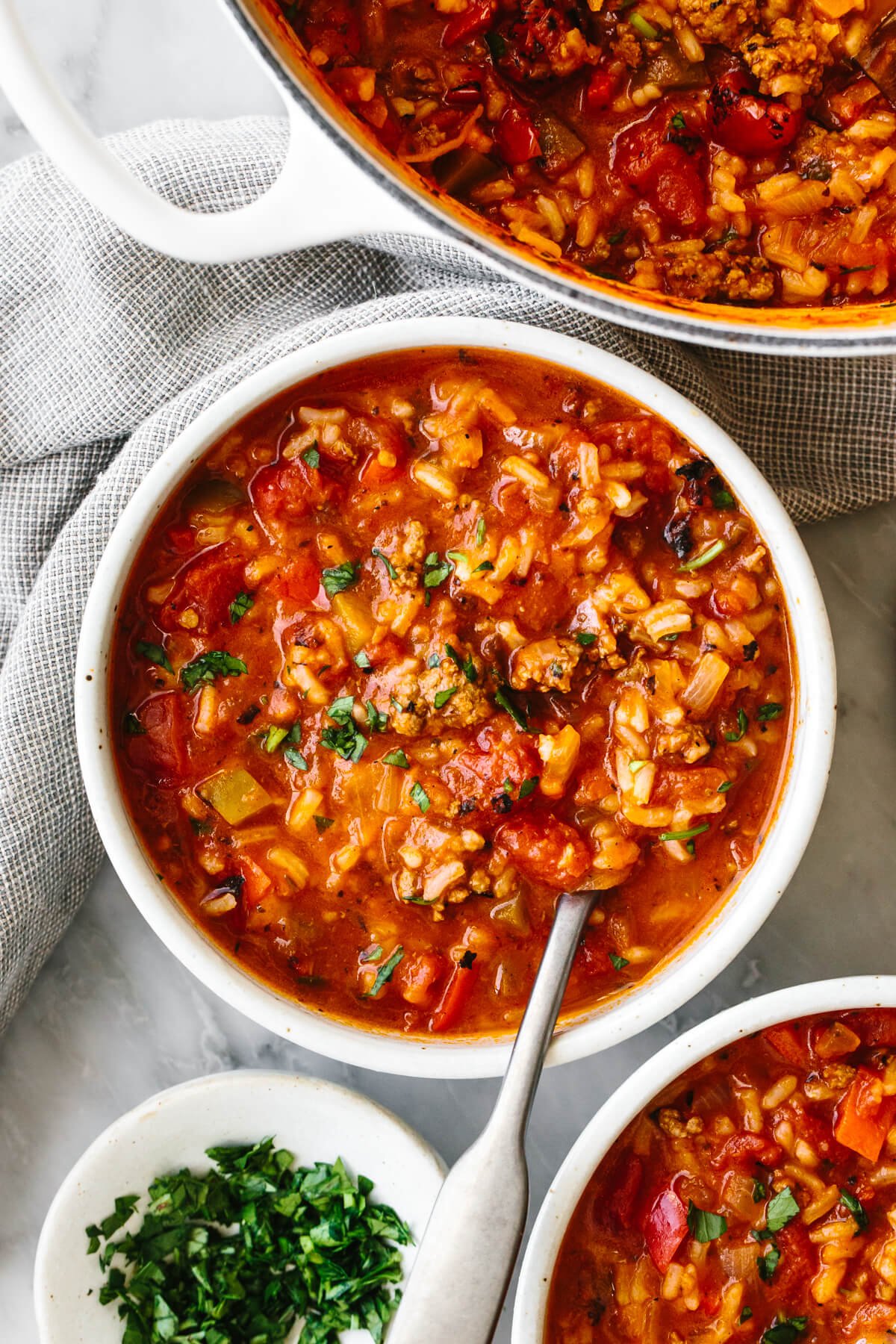 This easy stuffed pepper soup recipe turns a dinner favorite into an even cozier meal. It's homey, filling, and will leave everyone satisfied! This easy stuffed pepper soup recipe turns a dinner favorite into an even cozier meal. It's homey, filling, and will leave everyone satisfied! A bowl of stuffed pepper soup next to a napkin