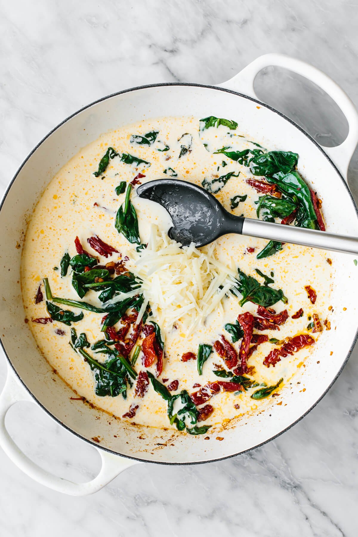 Steal hearts with this creamy tuscan chicken recipe! Seared Italian chicken simmers in a rich and creamy, spinach and sun-dried tomato sauce. Adding cream into a pan for tuscan chicken