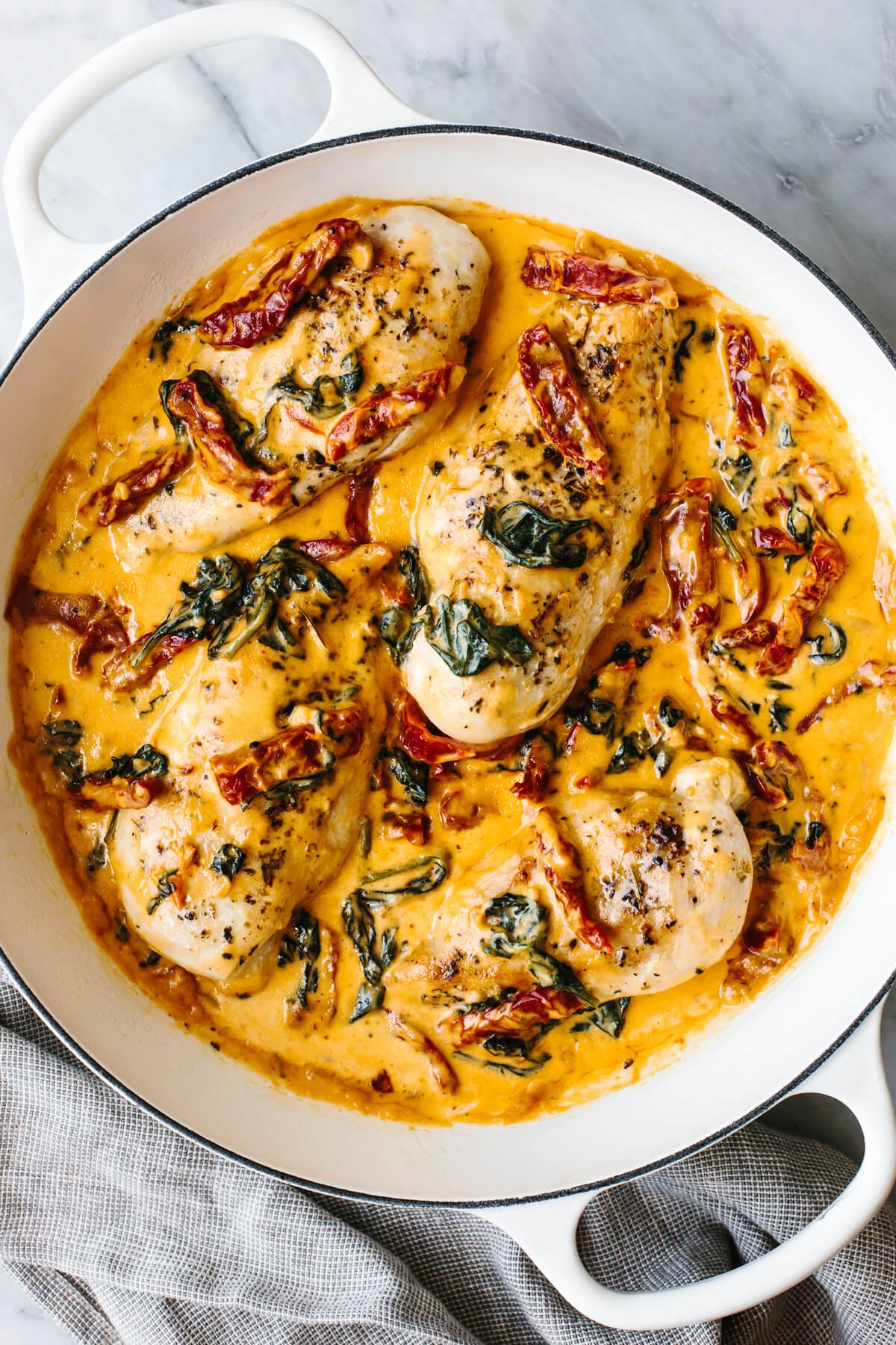 Steal hearts with this creamy tuscan chicken recipe! Seared Italian chicken simmers in a rich and creamy, spinach and sun-dried tomato sauce. A skillet of tuscan chicken