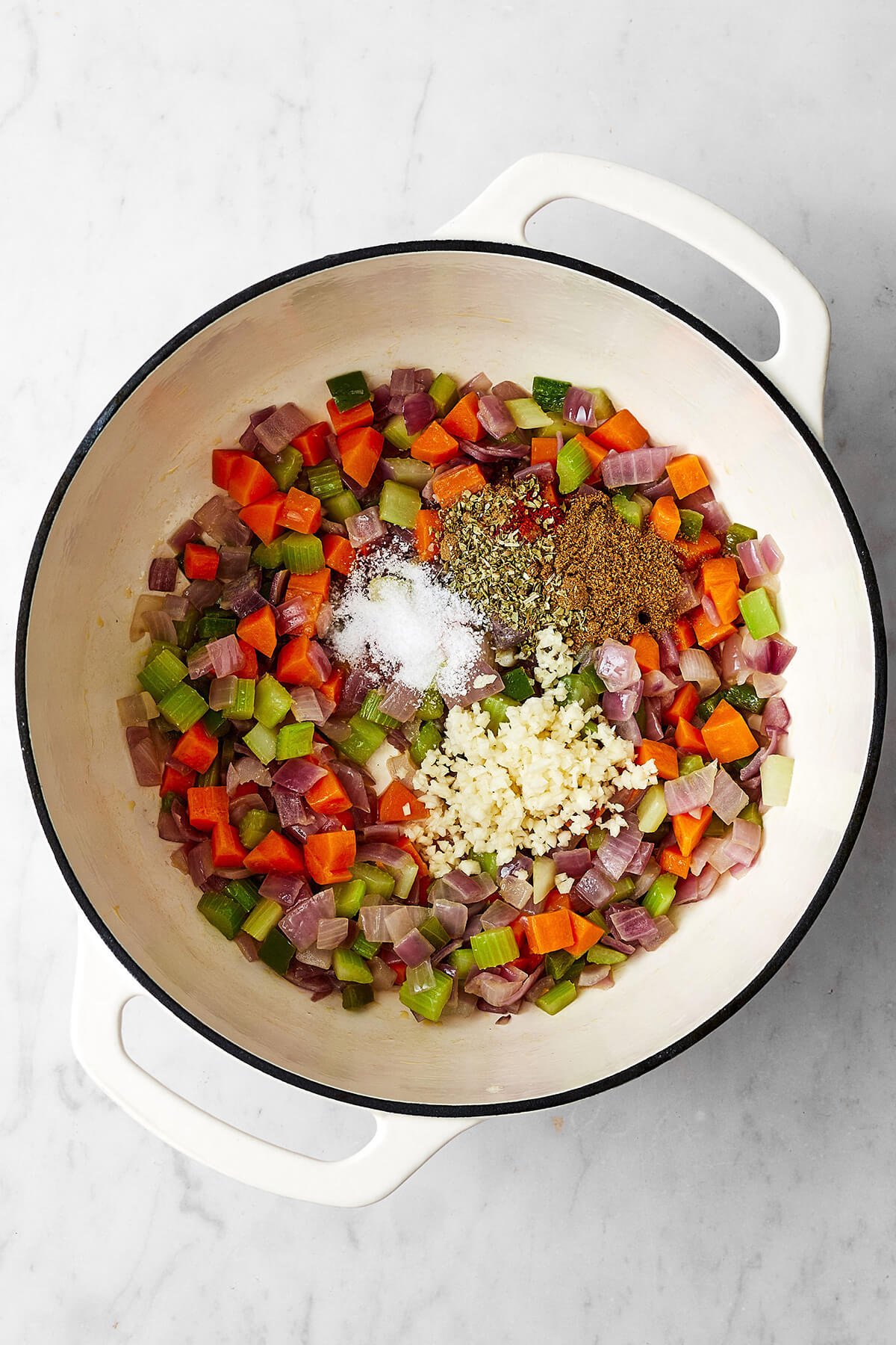 Don't look past this easy black bean soup recipe! It's a delicious vegetarian meal that's filling and layered with savory and spiced flavors. Cooking veggies in a pot for black bean soup