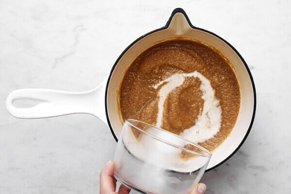 Stirring slurry into puree for spiced pear souffle