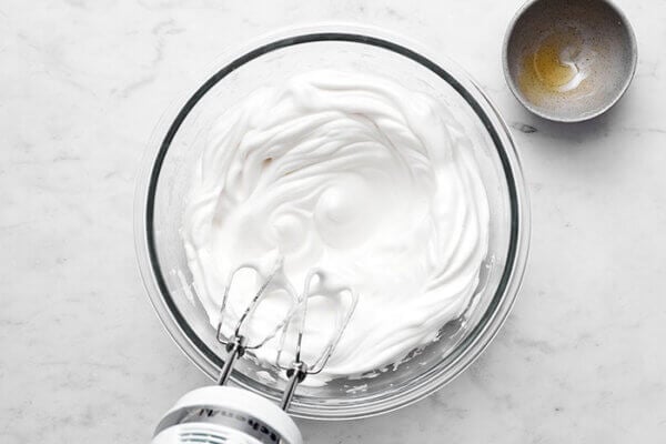 Whisking egg whites for spiced pear souffle