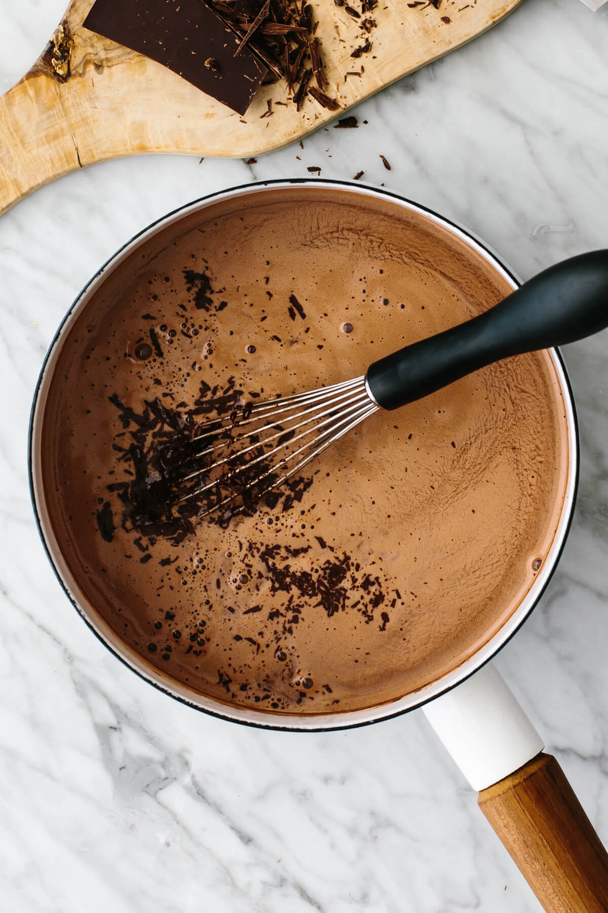 Mixing chocolate into warm milk.