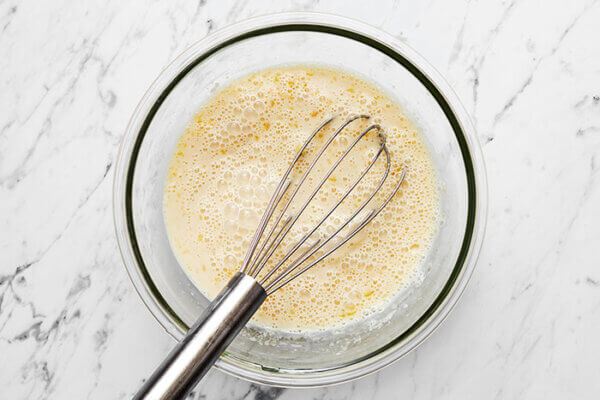 Whisking wet ingredients for berry baked oatmeal