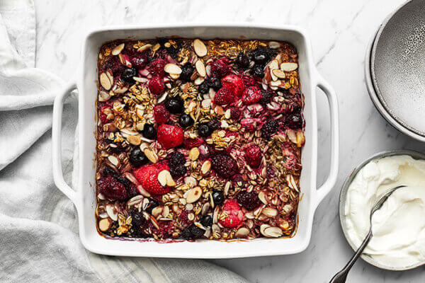 Berry baked oatmeal in a dish with a napkin next to it