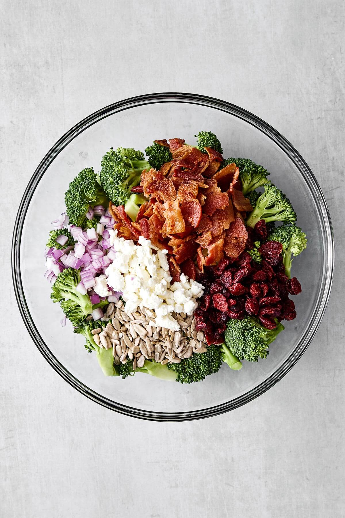 Broccoli salad in a glass bowl.