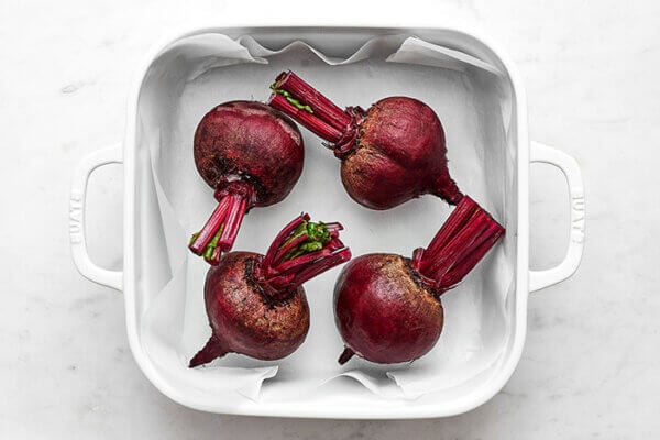 Prepping beets for roasting in a casserole dish
