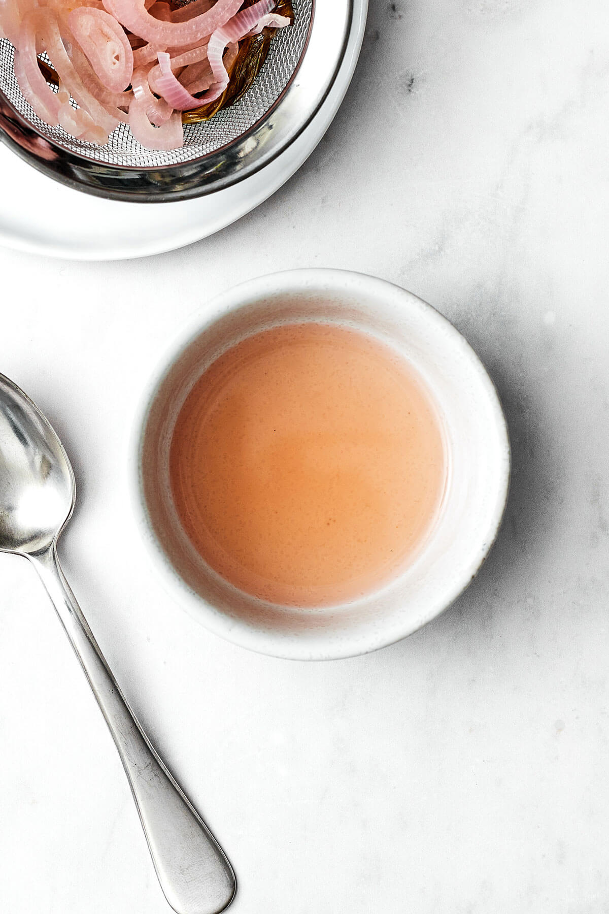 A drizzle of this easy béarnaise sauce will instantly elevate any dish! It has a luxurious butter wine base with hints of fresh tarragon. Infused vinegar in a bowl for bearnaise sauce