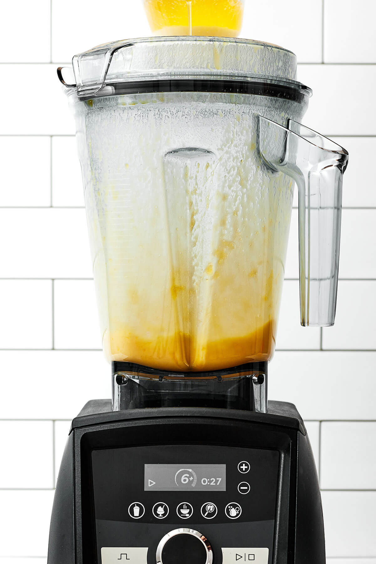 A drizzle of this easy béarnaise sauce will instantly elevate any dish! It has a luxurious butter wine base with hints of fresh tarragon. Streaming butter in blender for bearnaise sauce