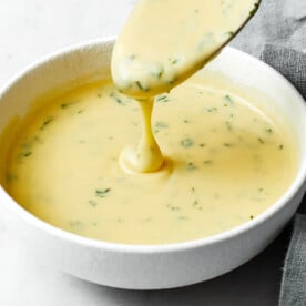 A white bowl of bearnaise sauce